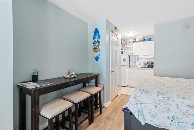 bedroom with light wood-style floors and baseboards