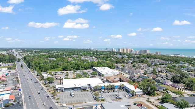 view of urban area with a large body of water and a major roadway