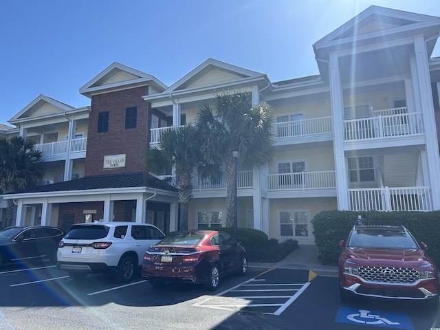 view of building exterior featuring uncovered parking