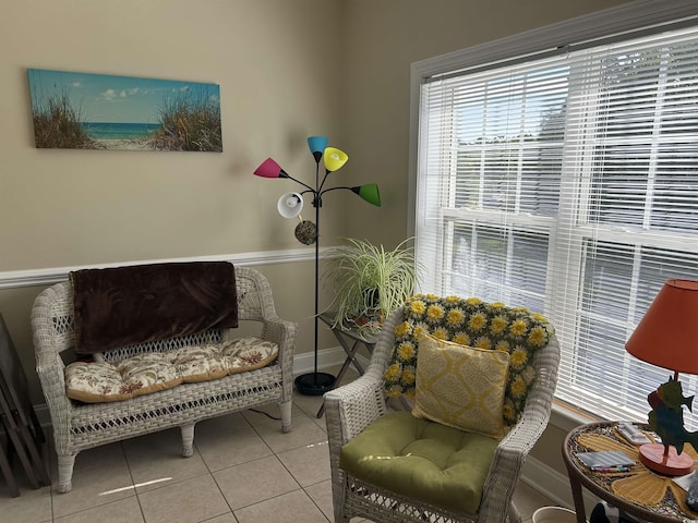 sitting room with baseboards and tile patterned flooring