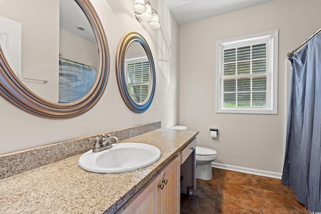 full bath with vanity, baseboards, and toilet