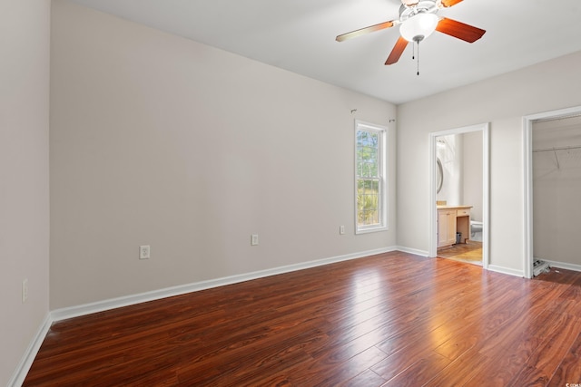 unfurnished bedroom with a ceiling fan, baseboards, wood finished floors, and a closet