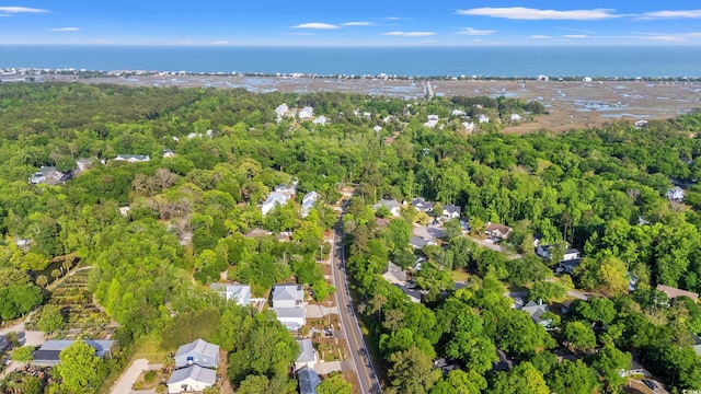 aerial view featuring a water view and a wooded view