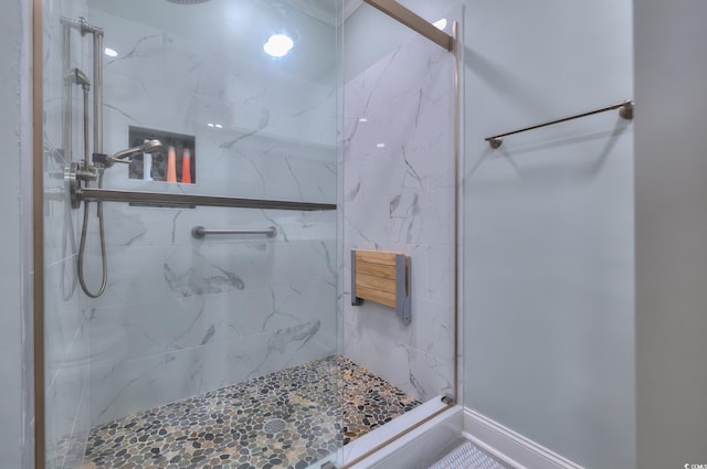 full bathroom with a marble finish shower