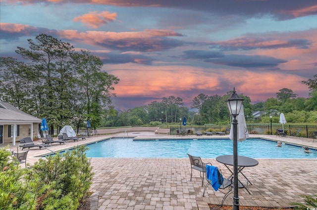 community pool featuring a patio and fence