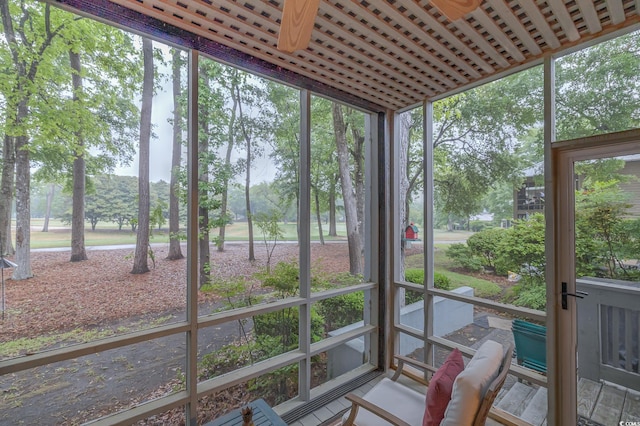 sunroom / solarium with a healthy amount of sunlight and a ceiling fan