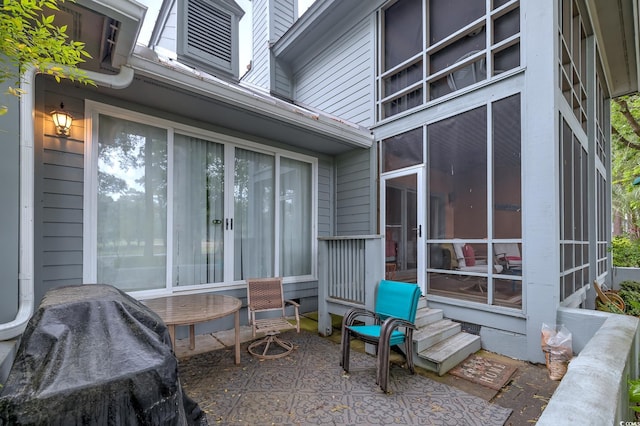 view of patio featuring a sunroom