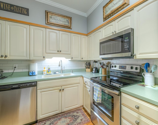 kitchen with a sink, light countertops, backsplash, and stainless steel appliances