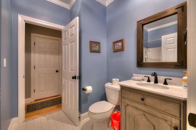 bathroom featuring crown molding, baseboards, tile patterned floors, and toilet