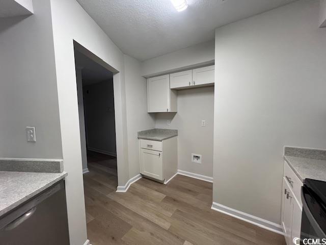 116 Hickory Dr, Conway, SC 29526 - kitchen featuring light wood-style flooring, stainless steel dishwasher, baseboards, white cabinetry, and light countertops