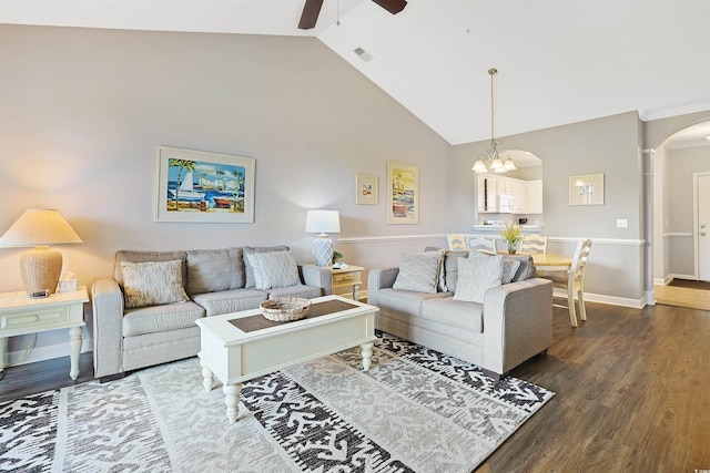living room featuring ceiling fan, arched walkways, high vaulted ceiling, dark wood finished floors, and visible vents