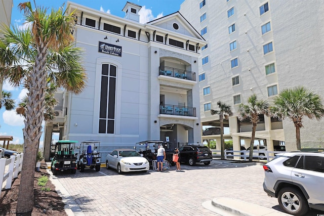 view of building exterior with uncovered parking