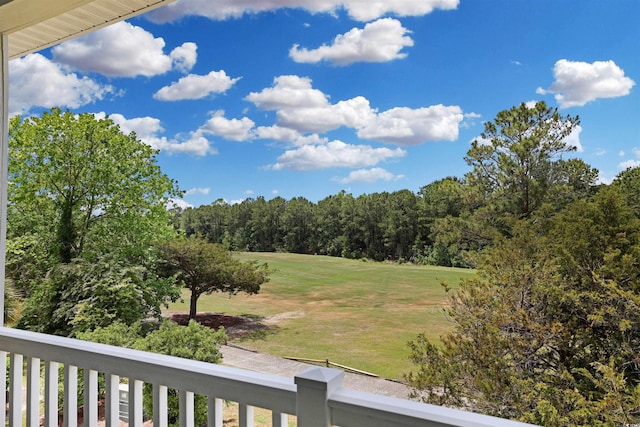 view of yard with a balcony and golf course view