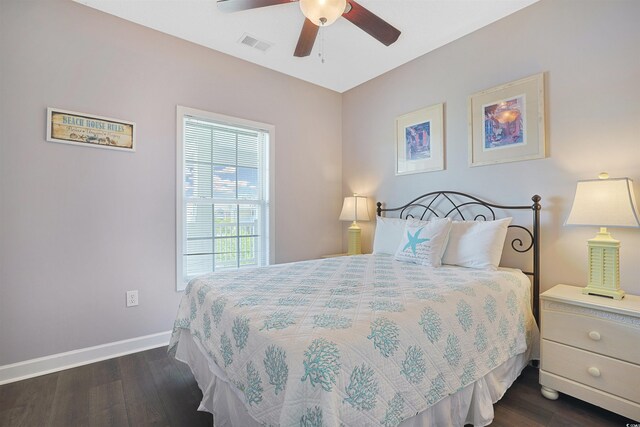bedroom with baseboards, ceiling fan, dark wood-type flooring, and visible vents