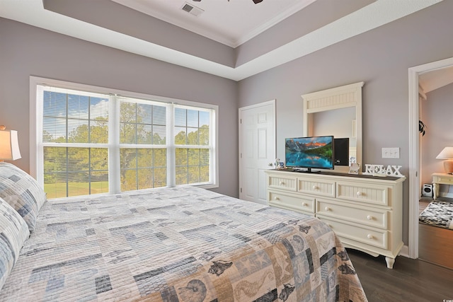 bedroom with visible vents, ornamental molding, and dark wood finished floors