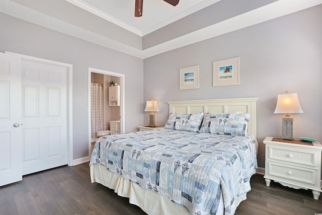 bedroom featuring crown molding, baseboards, ceiling fan, dark wood-type flooring, and connected bathroom