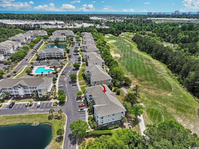 birds eye view of property featuring a water view, view of golf course, and a residential view