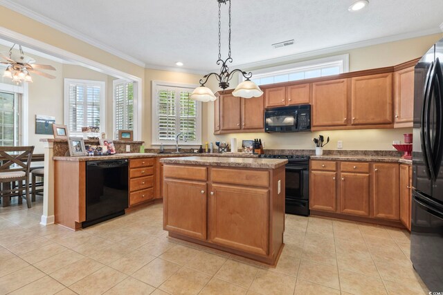 127 Willow Bay Dr, Murrells Inlet, SC 29576 - kitchen featuring brown cabinetry, a kitchen island, visible vents, a sink, and black appliances