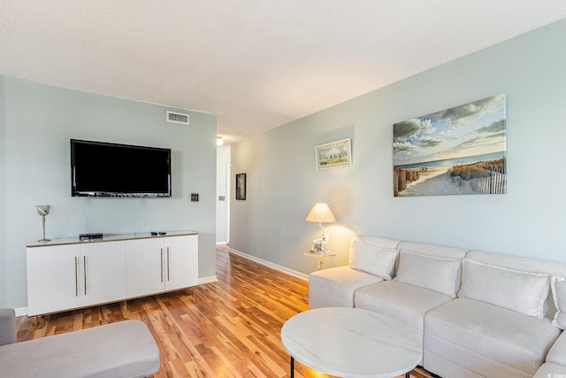 living room with light wood-style flooring and baseboards