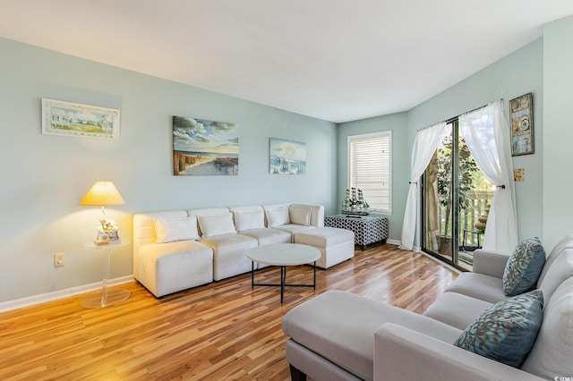 living area with light wood finished floors and baseboards