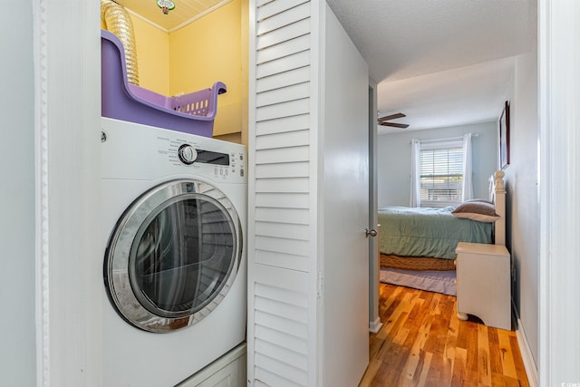 laundry area with washer / dryer and wood finished floors