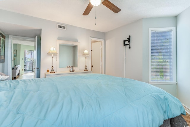 bedroom with wood finished floors and a ceiling fan