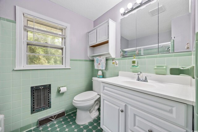 153 Busbee St, Conway, SC 29526 - bathroom featuring tile walls, toilet, vanity, wainscoting, and a textured ceiling