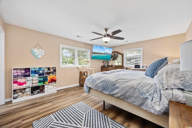 153 Busbee St, Conway, SC 29526 - bedroom with wood finished floors, baseboards, a ceiling fan, and a textured ceiling