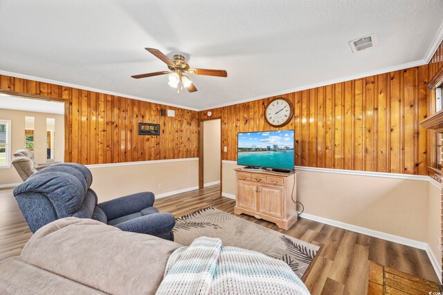 153 Busbee St, Conway, SC 29526 - living room with ceiling fan, crown molding, wood walls, wood finished floors, and baseboards