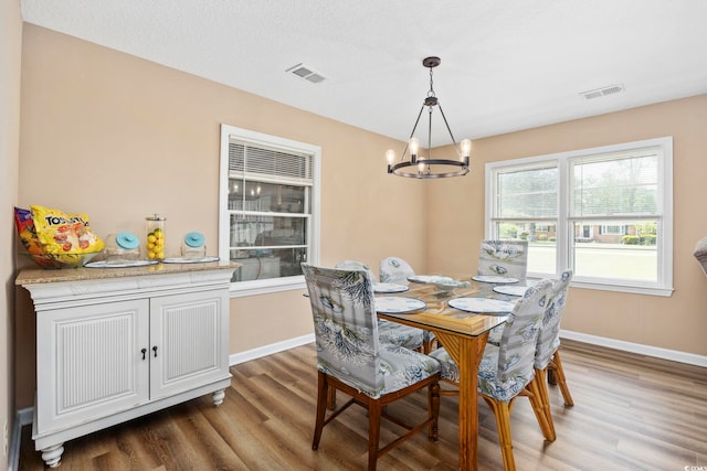 153 Busbee St, Conway, SC 29526 - dining space with a chandelier, wood finished floors, and baseboards