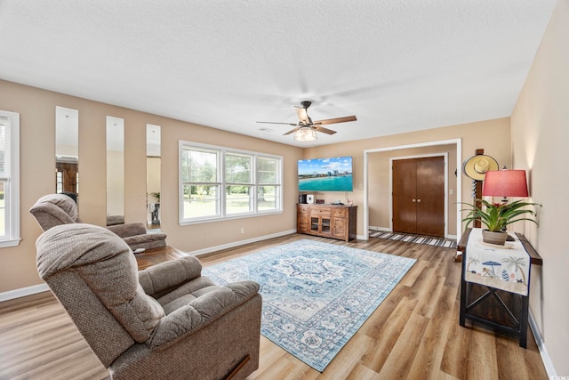 153 Busbee St, Conway, SC 29526 - living room featuring baseboards, a ceiling fan, light wood finished floors, and a textured ceiling