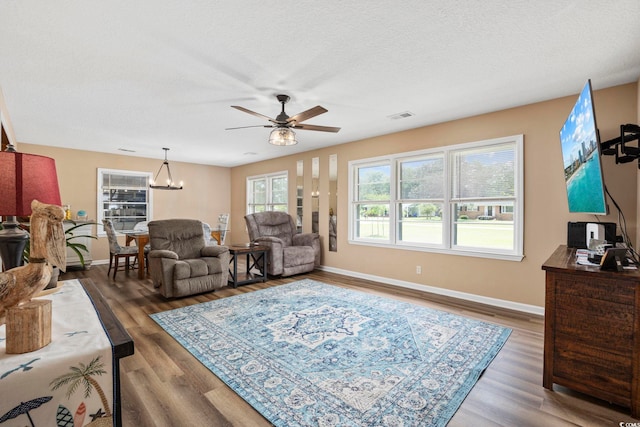153 Busbee St, Conway, SC 29526 - living area with ceiling fan, baseboards, a chandelier, wood finished floors, and a textured ceiling