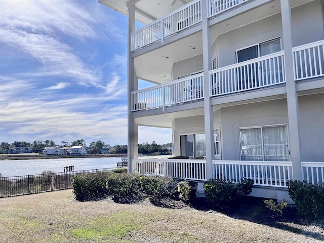 exterior space featuring fence and a water view