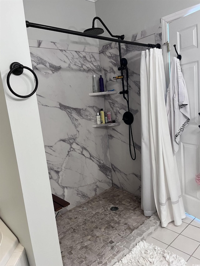 bathroom featuring a marble finish shower