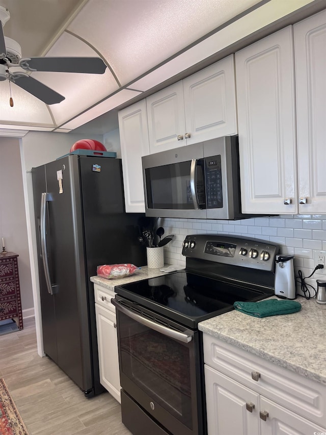 kitchen featuring tasteful backsplash, ceiling fan, stainless steel appliances, and white cabinetry