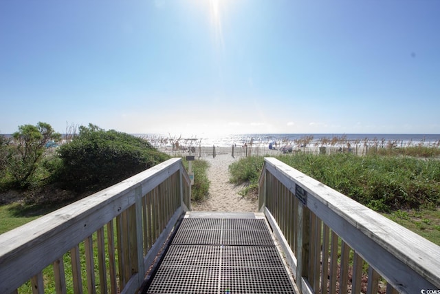 view of home's community with a water view and a view of the beach
