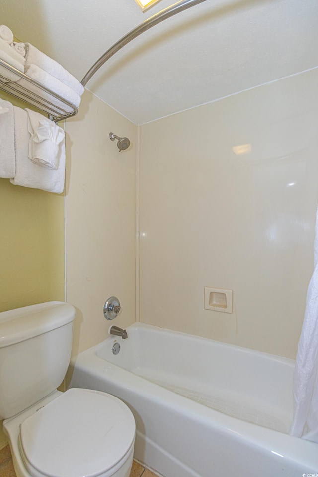 bathroom featuring toilet, shower / bathtub combination with curtain, and tile patterned flooring