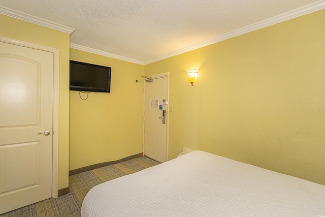 bedroom featuring crown molding, baseboards, and carpet