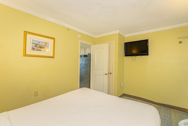carpeted bedroom featuring crown molding, baseboards, freestanding refrigerator, and a textured ceiling