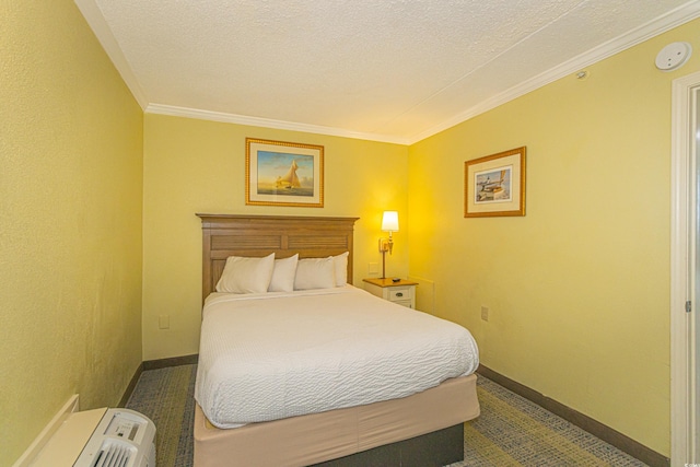 bedroom with crown molding, baseboards, and a textured ceiling