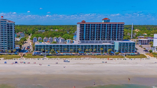 drone / aerial view featuring a water view and a view of the beach