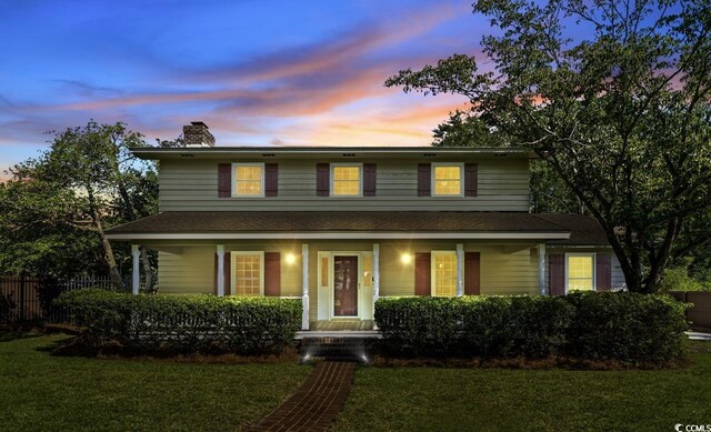 7602 Glenwood Dr, Myrtle Beach, SC 29572 - view of front of house with a porch, a chimney, and roof with shingles