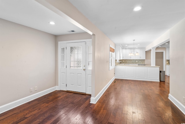7602 Glenwood Dr, Myrtle Beach, SC 29572 - kitchen with white cabinetry, dark wood-style floors, a chandelier, recessed lighting, and light countertops