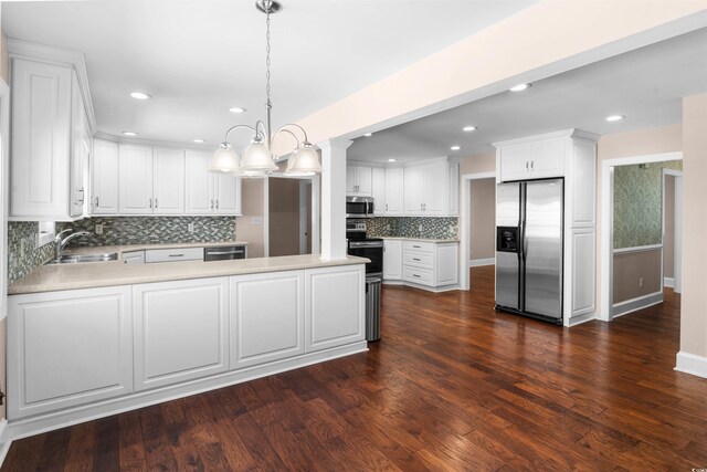 7602 Glenwood Dr, Myrtle Beach, SC 29572 - kitchen with appliances with stainless steel finishes, a peninsula, decorative backsplash, white cabinetry, and recessed lighting