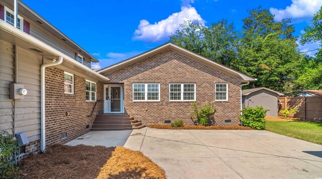7602 Glenwood Dr, Myrtle Beach, SC 29572 - view of front facade featuring crawl space, a patio area, a shed, and brick siding