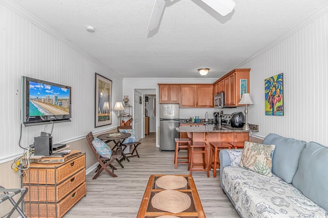 4516 Seaview St Unit 135, North Myrtle Beach, SC 29582 - living room with ornamental molding, light wood finished floors, a textured ceiling, and a ceiling fan