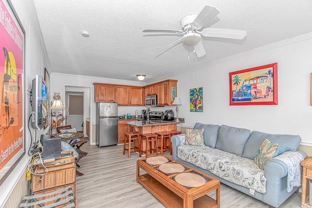 4516 Seaview St Unit 135, North Myrtle Beach, SC 29582 - living room with crown molding, ceiling fan, light wood-type flooring, and a textured ceiling
