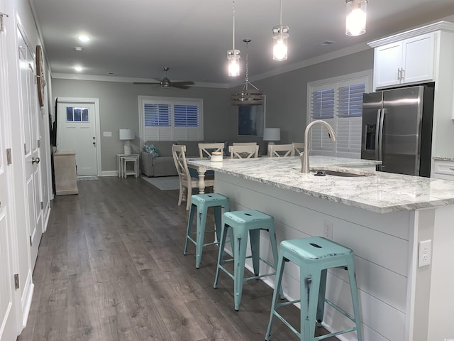 223 S 9th Ave S, North Myrtle Beach, SC 29582 - kitchen featuring stainless steel refrigerator with ice dispenser, ceiling fan, crown molding, a breakfast bar area, and white cabinets