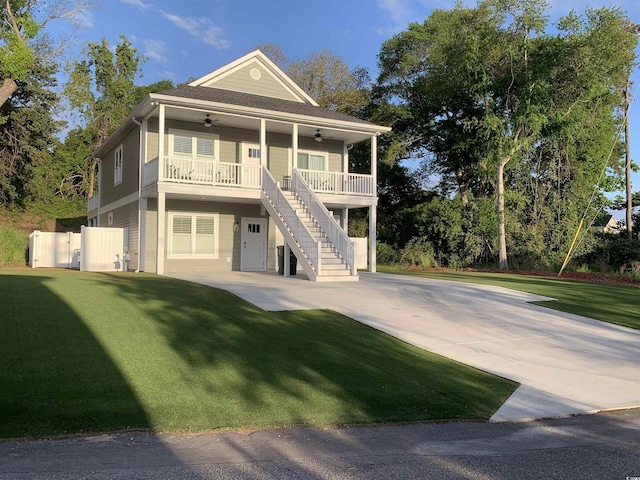 223 S 9th Ave S, North Myrtle Beach, SC 29582 - view of front of house with ceiling fan, stairway, driveway, and a front lawn