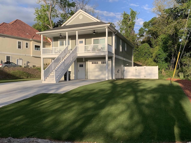 223 S 9th Ave S, North Myrtle Beach, SC 29582 - view of front of property with a ceiling fan, a porch, stairway, concrete driveway, and an attached garage